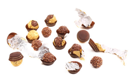 Bunch of chocolate gold bonbons. Isolated on a white background.