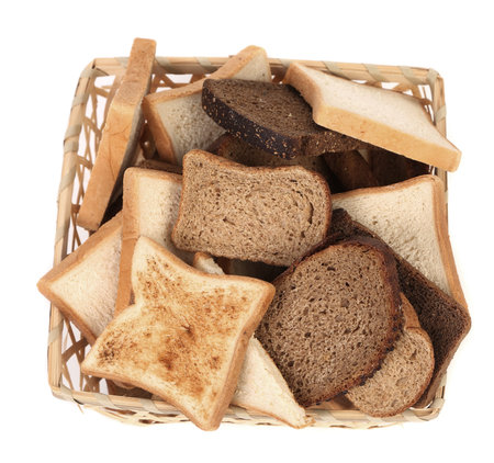 Full basket of different sliced bread. Isolated on a white background