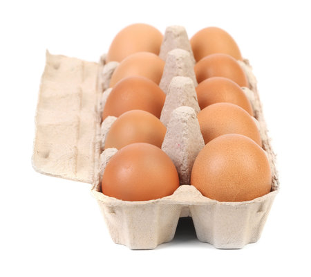 Brown eggs in egg box. Isolated on a white background