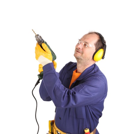 Worker in ear muffs and glasses with drill. Isolated on a white backgropund.の写真素材