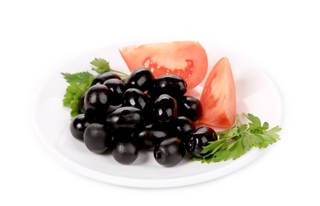Black olives with tomatoes and parsley. Isolated on a white background.の写真素材