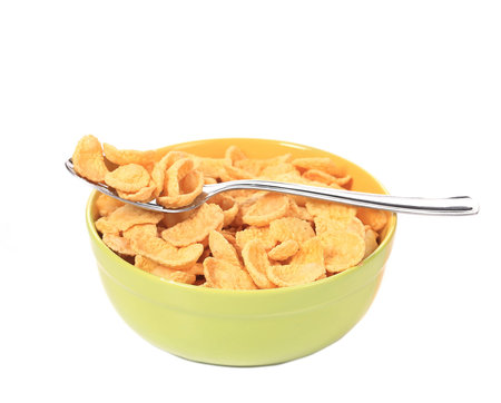 Bowl of sugar-coated corn flakes. Isolated on a white background.