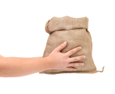 Hand holds bag of money. Isolated on a white background.