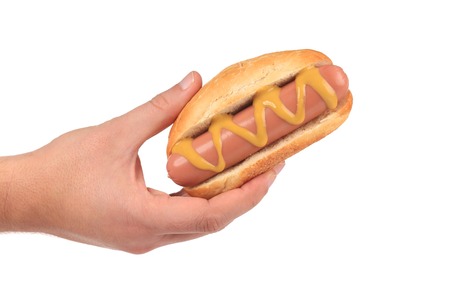 Hand hold hotdog with mustard  Isolated on a white の写真素材