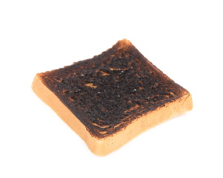 Burnt toast close up. Isolated on a white .の写真素材