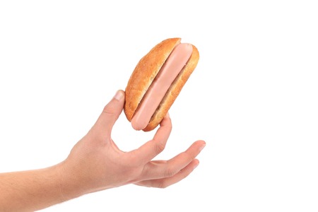Hand hold hotdog. Isolated on a white background.の写真素材