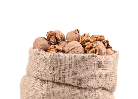Full bag with walnuts. Isolated on a white background.の写真素材