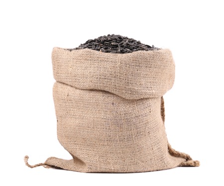 Full bag with sunflower seeds. Isolated on a white background.の写真素材