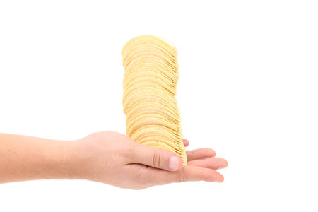Potato chips stack on hand. Isolated on a white background.の写真素材