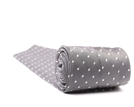 Folded gray tie with white speck. Isolated on a white background.の写真素材