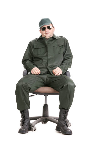 Worker in glasses sitting on chair. Isolated on a white background.の写真素材