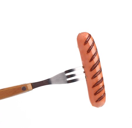 Grilled sausage on a fork. Isolated on a white background.の写真素材