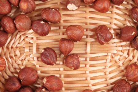 Close up of hazel nuts on a wicker basket. Whole background.の写真素材