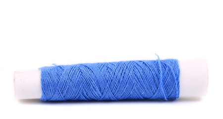Blue coil of threads close up. Isolated on a white background.の写真素材