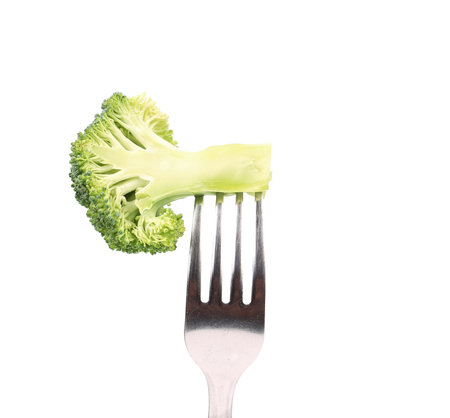Fresh broccoli on a fork. Isolated on a white .
