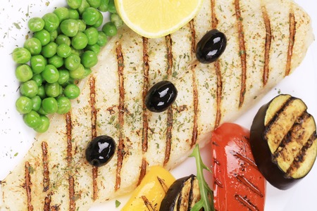 Pangasius fillet grilled with vegetables. Whole background.の写真素材