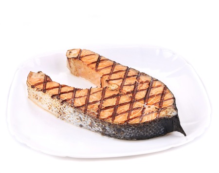 Close up of grilled salmon steak. Isolated on a white background.の写真素材