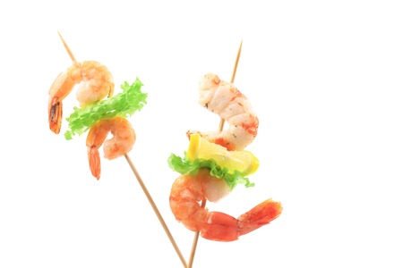 Grilled shrimps on a stick. Isolated on a white background.の写真素材