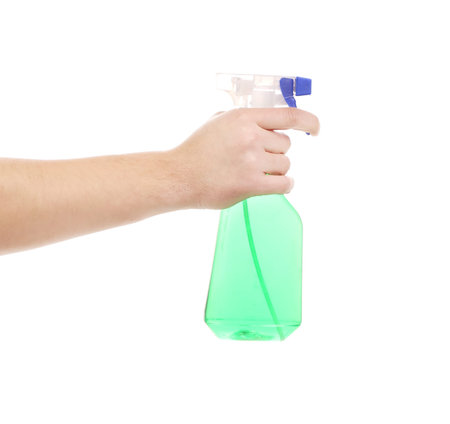 Hand holding blue plastic spray bottle. Isolated on a white background.