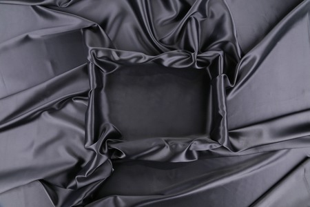 black silk square. Close up. Whole background. Texture.の写真素材
