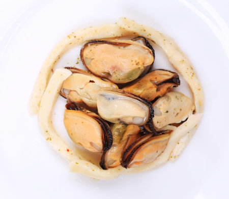 Mussels in a white plate. Isolated on a white background.