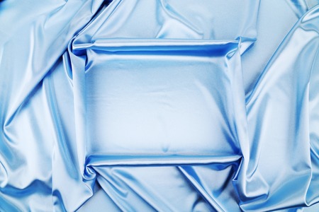 Blue silk background with some soft folds and highlightsの写真素材