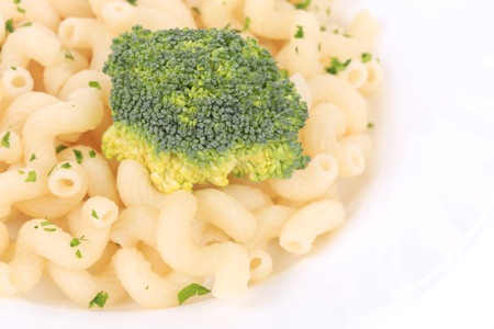 close up of pasta cavatappi with vegetables on a white plate. isolated on a white backgroundの写真素材
