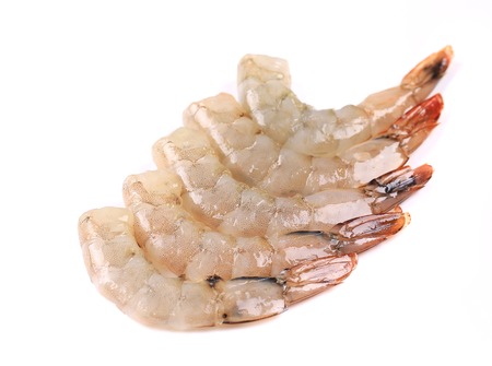 Peeled raw prawns. Isolated on a white background.の写真素材