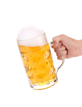 Male hand holding up a glass of beer. Isolated on a white background.の写真素材