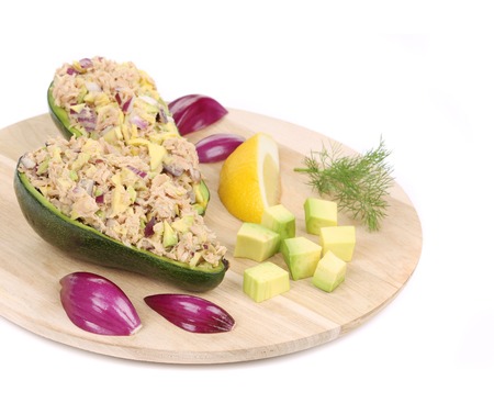 Avocado salad with tuna on platter. Isolated on a white background.の写真素材