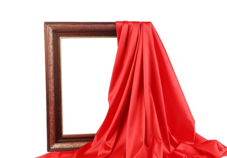 Old frame and red silk drapery. Isolated on a white background.の写真素材