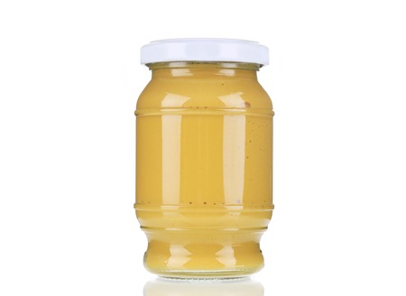 Mustard glass bottle. Isolated on a white background.の写真素材