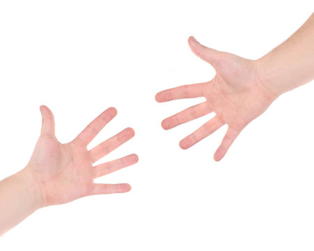 Two hand reaching each other. Isolated on a white background.