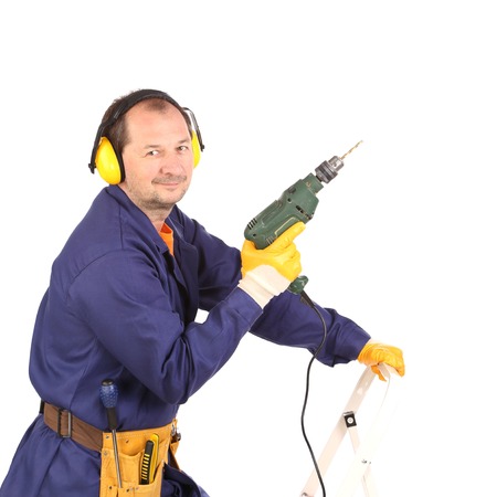 Worker standing with green drill.  Isolated on a white background.の写真素材