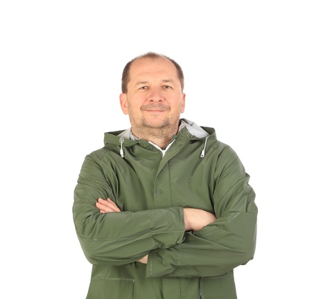 Man in green coat with crossed arms. Isolated on a white background.の写真素材