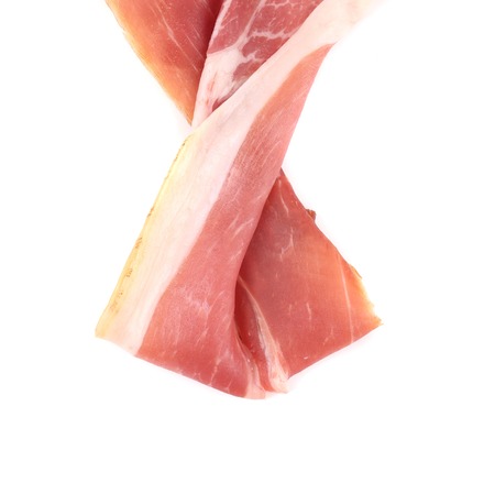 Slice of Delicious Prosciutto as Ribbon. Isolated on a white background.の写真素材