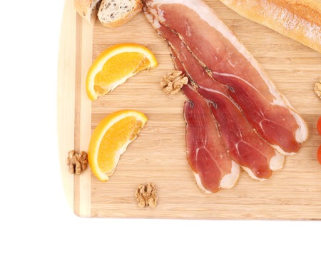 Prosciutto with cherry tomatoes and walnuts. Whole background.の写真素材