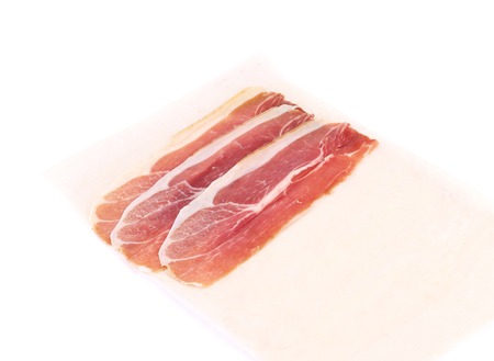 Slices of Delicious Prosciutto. Isolated on a white background.の写真素材