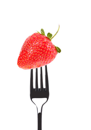 Strawberry on a fork. Isolated on a white background.の写真素材