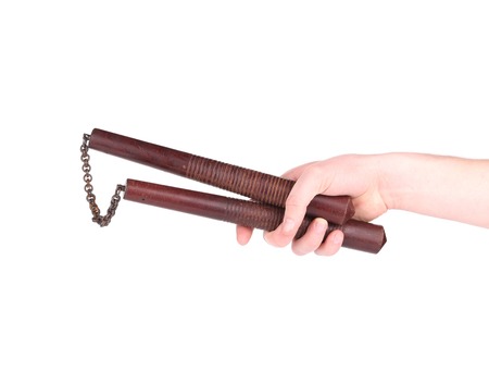 Martial arts nunchaku weapon in hand. Isolated on a white background.の写真素材