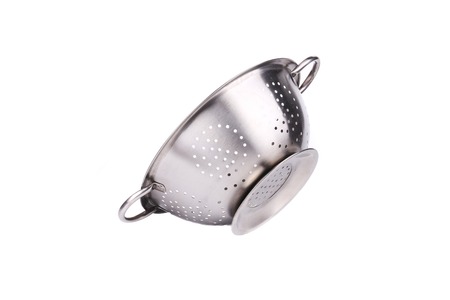 Steel strainer sieve metal bowl. Isolated on a white background.の写真素材