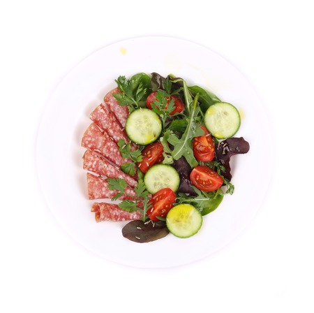 Salad with salami. Isolated on a white background.の写真素材
