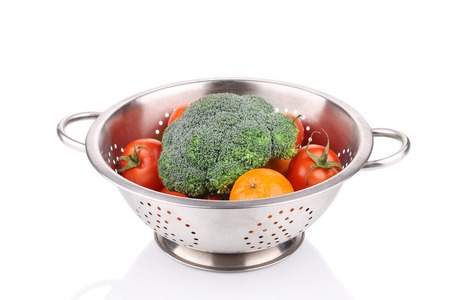 Vegetables in colander. Isolated on a white background.の写真素材