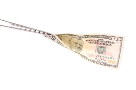 BBQ fork holds fifty dollar bill. Isolated on a white background.の写真素材