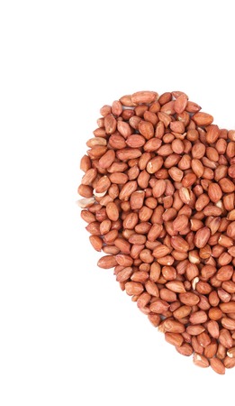 Heart shape of raw peanuts. Isolated on a white background.の写真素材