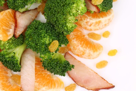 Broccoli salad with smoked ham and orange. Isolated on a white background.の写真素材