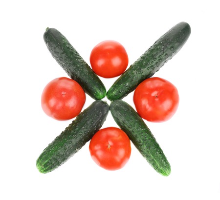 Cucumber and tomatoes cross. Isolated on a white background.の写真素材