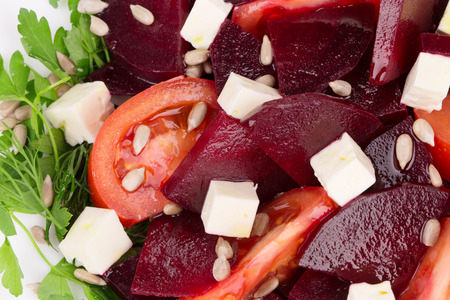 Closeup of beet salad with tomatoes and feta cheese.の写真素材