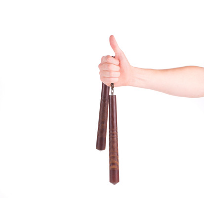 Hand holding nunchaku weapon. Isolated on a white background.の写真素材