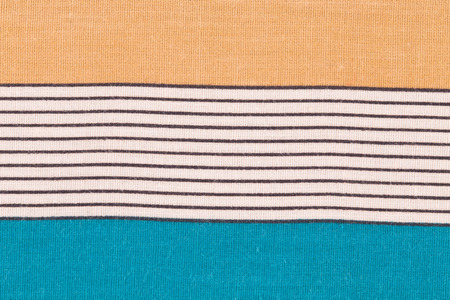 Close up of orange and blue tablecloth.の写真素材